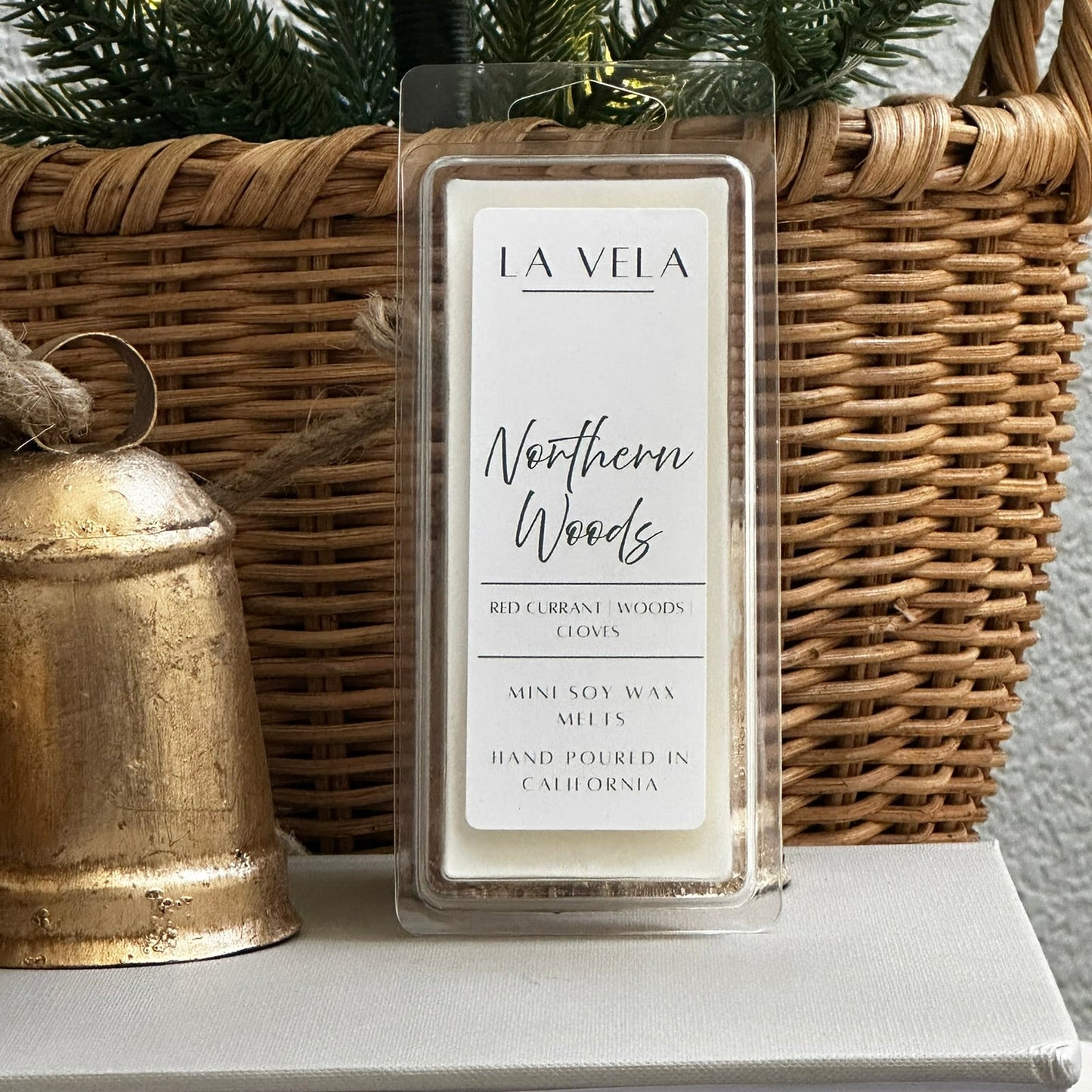 La Vela wax melt labeled 'Northern Woods' on a surface with decorative items.