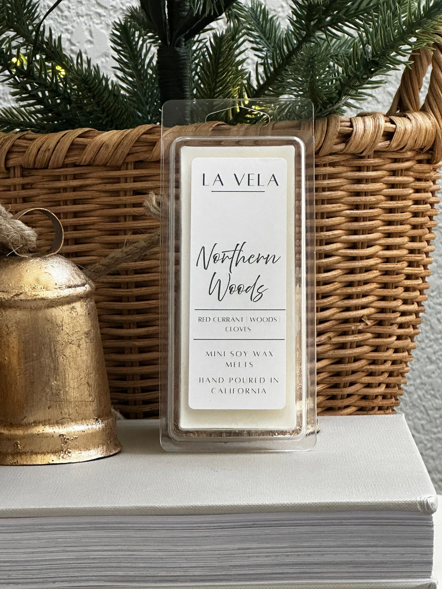 La Vela wax melt labeled 'Northern Woods' on a surface with decorative items.